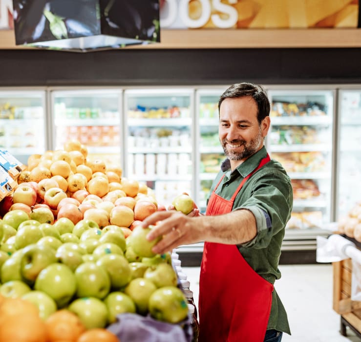man arranging fruit